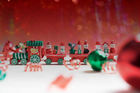 toy train on red bokeh background for christmasの写真素材
