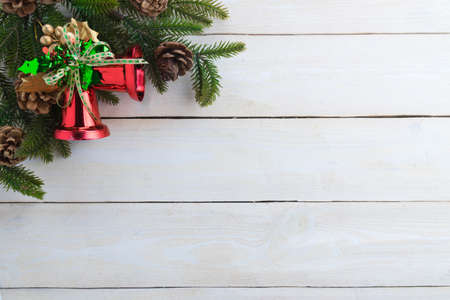 christmas bell fir geeen ribbon with text happy christmas on woodenの写真素材
