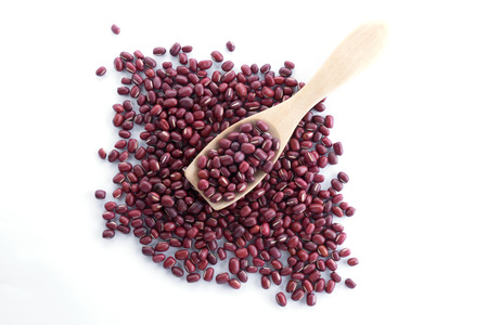 Red bean on wood spoon on white background