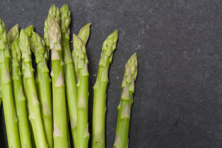 bunch of asparagus over slate backgroundの写真素材