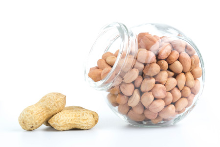 peanuts in glass bottles isolated on white background
