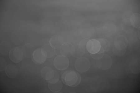 silver and white bokeh lights abstract backgroundの写真素材