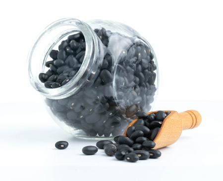 black beans on glass bottles with white backgroundの写真素材