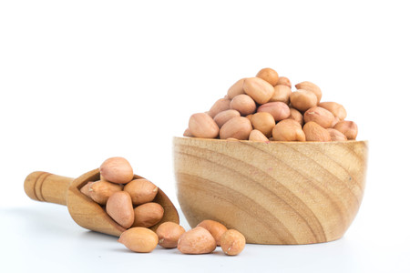 peanuts in wood cup  isolated on white backgroundの写真素材