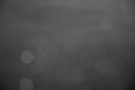 silver and white bokeh lights abstract backgroundの写真素材