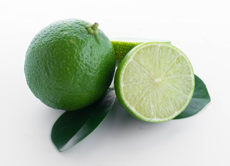 lime fruit with a half isolated on white background