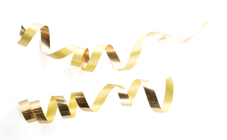 Golden ribbon roll isolated on white backgroundの写真素材