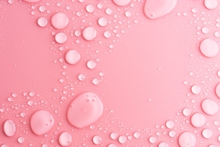 water drops on pink backgroundの写真素材