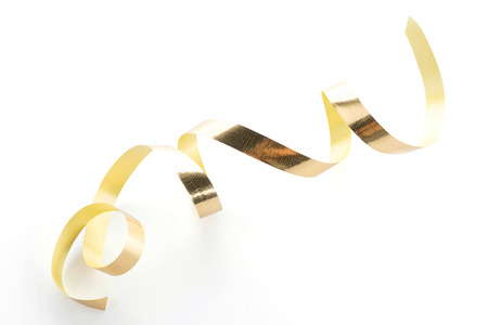 Golden ribbon roll isolated on white backgroundの写真素材
