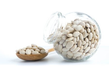 white beans in glass bottles isolated white background