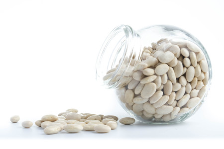 white beans in glass bottles isolated white backgroundの写真素材