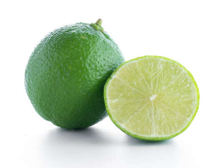 lime fruit with a half isolated on white backgroundの写真素材