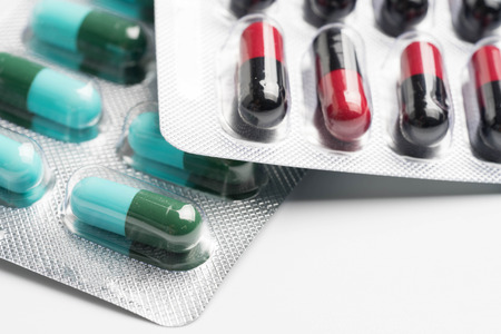 selective focus of antibiotic capsules pills on blur background with copy space drug