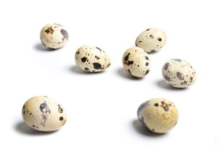 Group quail eggs are isolated on a white background