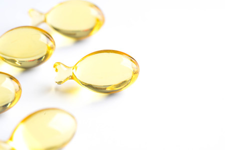 omega capsules on white background fish shape