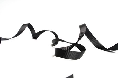 beautiful black ribbon twist spiral isolated on white backgroundの写真素材