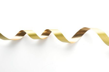 Golden ribbon roll isolated on whiteの写真素材