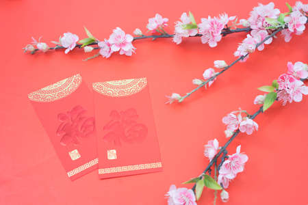 chinese new year celebration with angpao red and plum flowers on red background