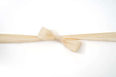 Burlap woven ribbon bow isolated on whiteの写真素材