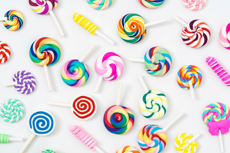 Colorful lollipop and different colored round candy top view