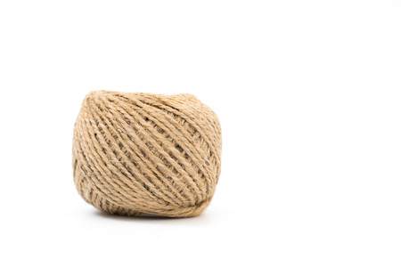 Skein of jute rope with loose end on white