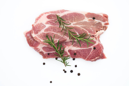 resh raw pork neck meat pepper and rosemary isolated on white background