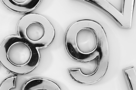 Silver scattered numbers on the table for mathematics concept
