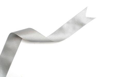 Silver ribbon in roll on whiteの写真素材