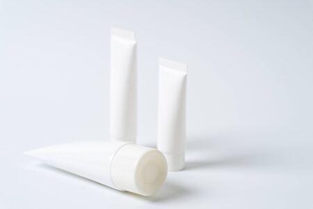 white realistic glossy cosmetic tubes on whiteの写真素材