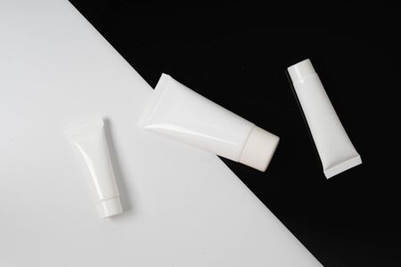 white realistic glossy cosmetic tubes on back and white