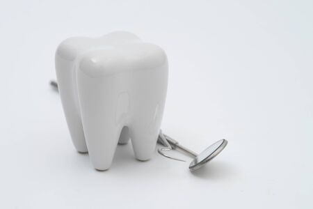 Teeth model and dentist tool on white backgroundの写真素材