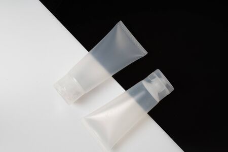 White realistic glossy cosmetic tubes on back and whiteの写真素材