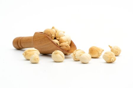 Dried spices herbs siam cardamom wooden spoon on whiteの写真素材