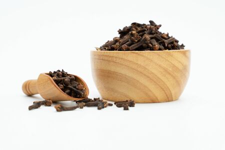 dried cloves wooden bowl on white backgroundの写真素材