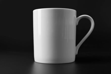white ceramic mug isolated on black backgroundの写真素材