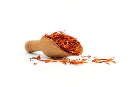 saffron spice wooden spoon on white backgroundの写真素材