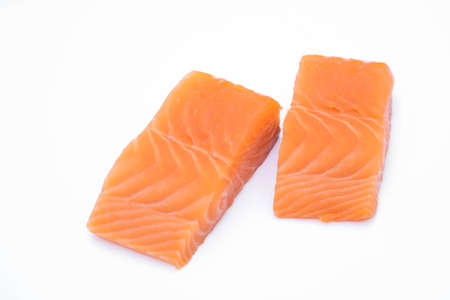 fresh raw salmon fillets isolated on white backgroundの写真素材