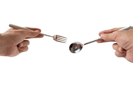 hand holding silver fork and spoon on white backgroundの写真素材