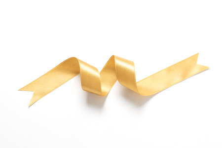 A roll gold color ribbon isolated on white backgroundの写真素材