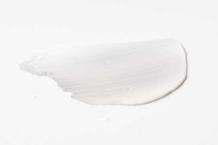 white cosmetic face cream texture on white backgroundの写真素材