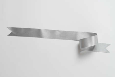 A roll silver ribbon isolated on white backgroundの写真素材