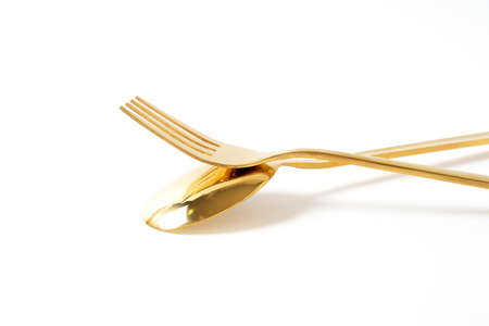 gold spoon and fork isolate on white backgroundの写真素材