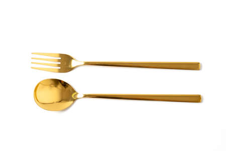 gold spoon and fork isolate on white backgroundの写真素材
