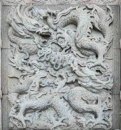 wall dragon stone sculpture backgroundの写真素材