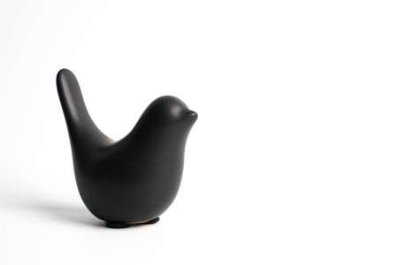 Black ceramic bird on white backgroundの写真素材