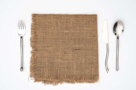 setting spoon fork knife on sack white backgroundの写真素材