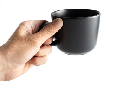 black ceramic coffee mug on hand backgroundの写真素材