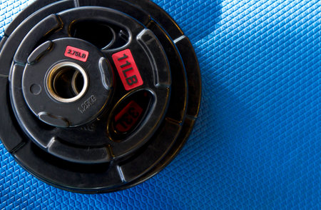 Weight lifting equipment on blue gym matの写真素材
