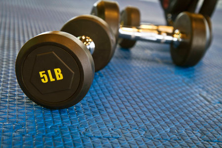 Weight lifting equipment on blue gym matの写真素材