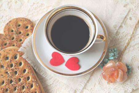 Cup of coffee and felt hearts. Morning coffee. Top view, soft focus. Special toning.の写真素材